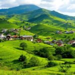 Pemandangan alam Brebes dengan bukit hijau dan rumah tradisional.